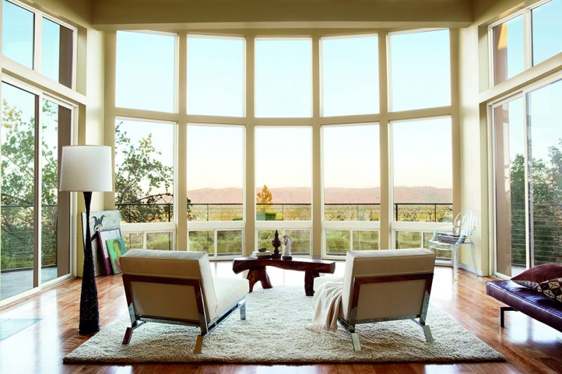 A living area with large casement windows filling the walls