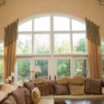 cureved single pane windows above glass french doors