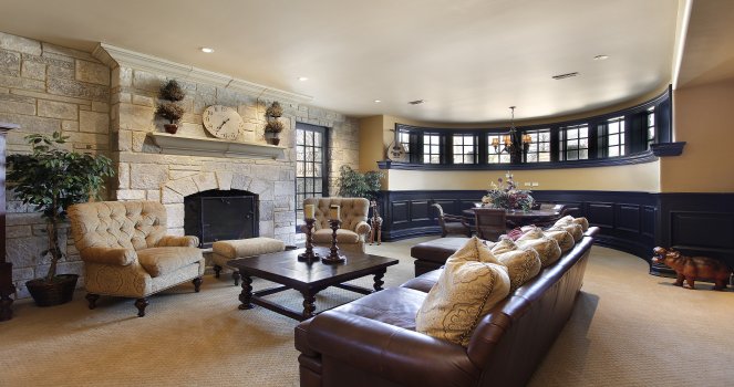 a living room with couches, chairs and a fireplace