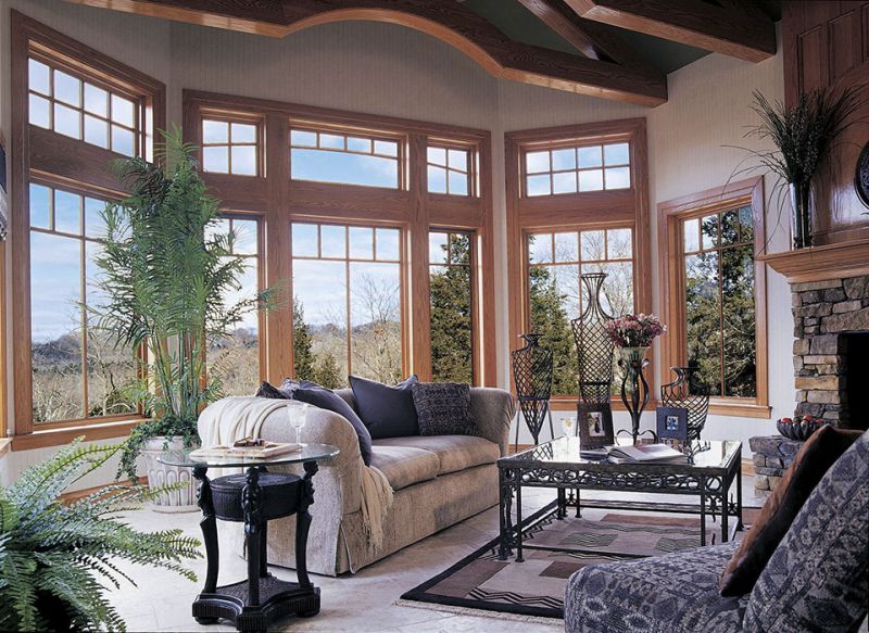 a living room filled with furniture and large windows