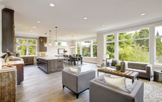 An open concept kitchen and living room with giant windows