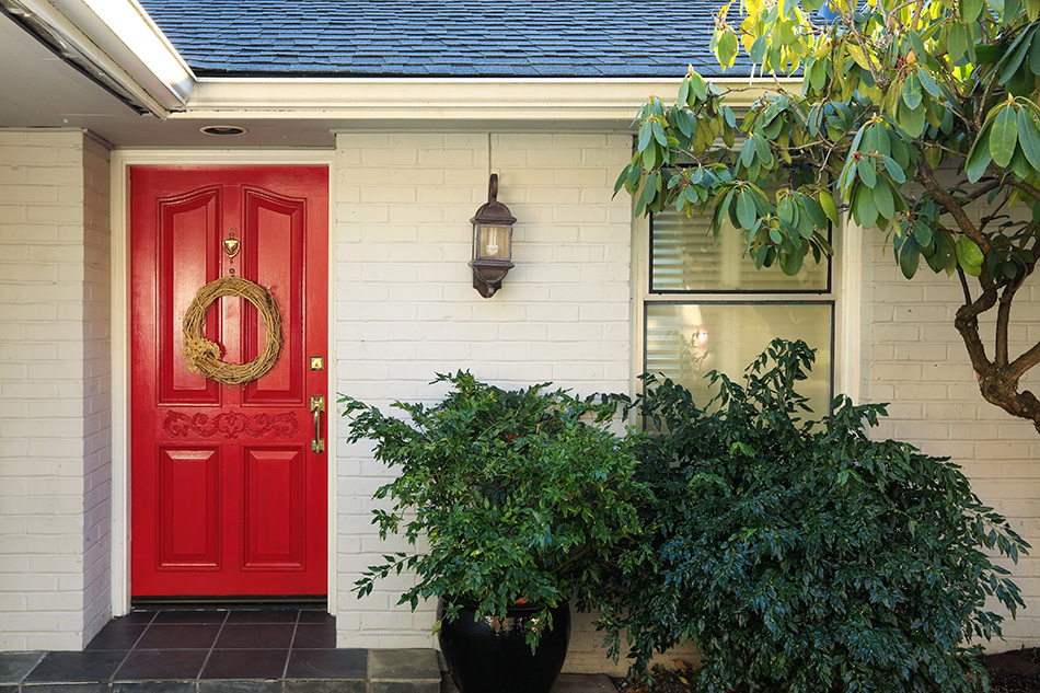 White Brick Front Porch With Red Door