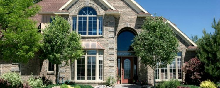 Beautiful stone home exterior with newly installed windows.