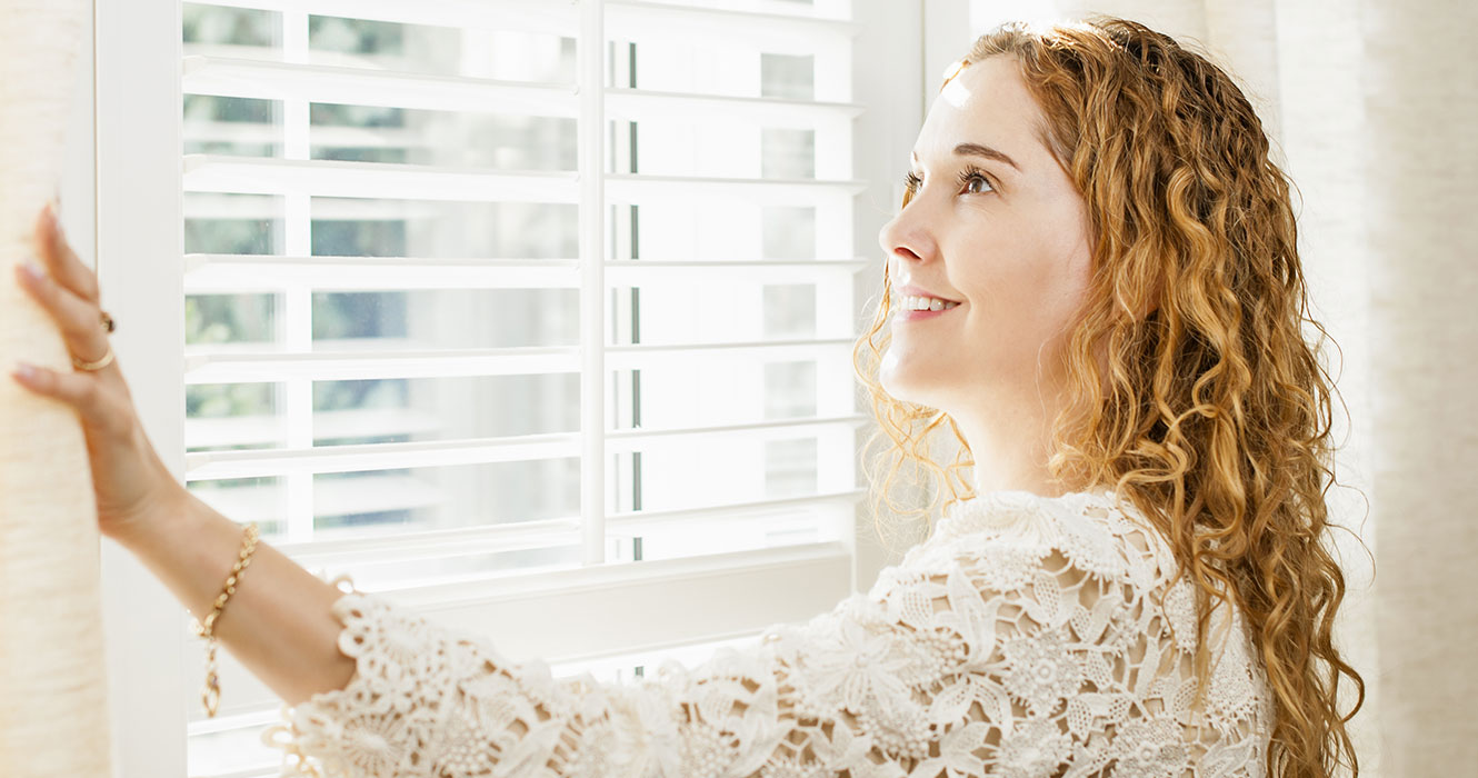 woman looking out her Zen Window smiling