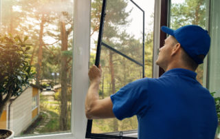 worker installing a house window