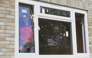 Construction worker installing new windows